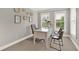 Office space with white desk, three chairs, and bright natural light from two windows at 201 Beacon Cv, Canton, GA 30114