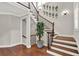 Beautiful staircase with wood treads, iron balusters, and decorative wall accents at 201 Beacon Cv, Canton, GA 30114