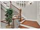 This staircase features dark wood steps, white risers, and a wrought iron railing at 201 Beacon Cv, Canton, GA 30114