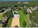 Aerial view showcasing the estate, including horse training area, stables, and fenced acreage at 206 Savanna Estates Ct, Canton, GA 30115