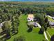 Expansive aerial view of a property featuring a house, horse stables, and a surrounding forest at 206 Savanna Estates Ct, Canton, GA 30115