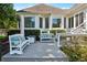 Inviting back deck featuring comfortable benches, lush greenery, and elegant windows at 206 Savanna Estates Ct, Canton, GA 30115