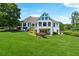 Expansive backyard featuring lush green grass, mature trees, and partial view of the house at 206 Savanna Estates Ct, Canton, GA 30115
