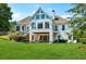 A well-maintained backyard showing the exterior of the house with large windows and manicured lawn at 206 Savanna Estates Ct, Canton, GA 30115