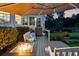 Cozy outdoor space with a fire pit, comfortable seating, and elegant patio umbrella on a wooden deck, perfect for relaxation at 206 Savanna Estates Ct, Canton, GA 30115