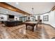 Open basement design showcasing a pool table, wet bar, and comfortable seating area at 206 Savanna Estates Ct, Canton, GA 30115