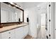 Bright bathroom with granite countertop, wood flooring, and large vanity mirror at 206 Savanna Estates Ct, Canton, GA 30115