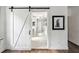 Bathroom doorway showcasing a white barn door and tiled flooring at 206 Savanna Estates Ct, Canton, GA 30115