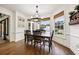 Sunlit breakfast nook with windows, wood floors, and a view of the landscaped backyard at 206 Savanna Estates Ct, Canton, GA 30115