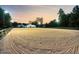 Large equestrian arena with meticulously groomed sand, sturdy perimeter fencing, and ample space for riding and training at 206 Savanna Estates Ct, Canton, GA 30115