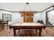 Spacious game room featuring a pool table with elegant lighting and beautiful hardwood flooring at 206 Savanna Estates Ct, Canton, GA 30115
