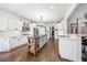 Bright kitchen features a large island, white cabinets, stainless appliances, and hardwood flooring at 206 Savanna Estates Ct, Canton, GA 30115