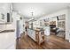 A modern kitchen with white cabinetry, stainless appliances, kitchen island, and views into the living area at 206 Savanna Estates Ct, Canton, GA 30115