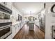 A spacious kitchen is equipped with stainless steel appliances, white cabinets, and a functional center island at 206 Savanna Estates Ct, Canton, GA 30115