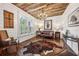 Cozy living room featuring wood-paneled ceiling, ample natural light, and stylish décor at 206 Savanna Estates Ct, Canton, GA 30115