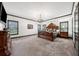 The main bedroom with a large bed, a chandelier, and natural light from multiple windows at 206 Savanna Estates Ct, Canton, GA 30115
