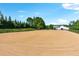View of the horse riding arena with trees in the background at 206 Savanna Estates Ct, Canton, GA 30115