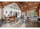 Cozy sunroom with a stone floor, wood beam ceiling, comfortable seating, and plenty of light at 206 Savanna Estates Ct, Canton, GA 30115