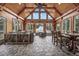 Sunroom featuring wood beams, stone floors, comfortable seating, and an adjacent dining area at 206 Savanna Estates Ct, Canton, GA 30115