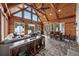 Vaulted wood paneled sunroom with rustic elements, stone floors, and natural light at 206 Savanna Estates Ct, Canton, GA 30115