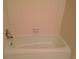 Bathroom featuring a white tiled tub and shower combo at 3117 Reeves Se St, Smyrna, GA 30080