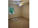 Carpeted bedroom with a ceiling fan and natural light from the window overlooking the yard at 3117 Reeves Se St, Smyrna, GA 30080