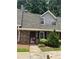 Charming brick townhouse featuring a well-maintained front entrance and landscaped bushes at 3117 Reeves Se St, Smyrna, GA 30080