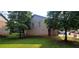 Back of home view of brick and siding with lawn at 5719 Singlebriar Ct, Norcross, GA 30093