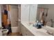 Well-lit bathroom featuring a double vanity, large mirror, and tiled shower at 5719 Singlebriar Ct, Norcross, GA 30093