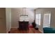 View of dining area with modern light fixture and outdoor access at 5719 Singlebriar Ct, Norcross, GA 30093