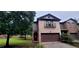 Charming two-story brick home with a covered entry, two car garage, and landscaped front yard at 5719 Singlebriar Ct, Norcross, GA 30093