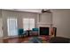 Open-concept living room with fireplace and an abundance of natural light at 5719 Singlebriar Ct, Norcross, GA 30093