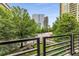 Balcony view featuring a vibrant cityscape surrounded by lush greenery at 700 Park Regency Ne Pl # 703, Atlanta, GA 30326