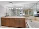 Elegant bathroom with a soaking tub, dual sinks, and a large mirror at 700 Park Regency Ne Pl # 703, Atlanta, GA 30326
