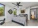 Cozy bedroom featuring a large window, a ceiling fan, and neutral décor at 700 Park Regency Ne Pl # 703, Atlanta, GA 30326