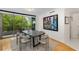 Dining room with a black table, and a balcony that overlooks a lush green neighborhood at 700 Park Regency Ne Pl # 703, Atlanta, GA 30326
