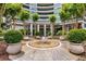 Grand building entrance with decorative fountain, manicured landscaping, and welcoming covered entry at 700 Park Regency Ne Pl # 703, Atlanta, GA 30326