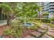 Serene outdoor fountain surrounded by lush landscaping and a walking path near the building at 700 Park Regency Ne Pl # 703, Atlanta, GA 30326