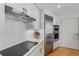 Modern kitchen with subway tile backsplash, stainless appliances, sleek range hood and hardwood floors at 700 Park Regency Ne Pl # 703, Atlanta, GA 30326