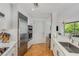 Eat-in kitchen features stainless steel appliances, marble countertops, white cabinets and hardwood floors at 700 Park Regency Ne Pl # 703, Atlanta, GA 30326