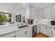 Modern kitchen with stainless steel appliances, quartz countertops, and a bar at 700 Park Regency Ne Pl # 703, Atlanta, GA 30326