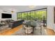 Bright living room featuring hardwood floors, large windows, and modern furnishings at 700 Park Regency Ne Pl # 703, Atlanta, GA 30326