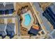 Aerial view of community pool with modern lounge areas, surrounding homes and sidewalks at 164 Inwood Walk, Woodstock, GA 30188