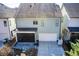 Aerial view of the back exterior with screened in porch and stone patio at 164 Inwood Walk, Woodstock, GA 30188