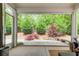 Cozy back porch offering privacy and a beautiful view of the meticulously landscaped backyard at 164 Inwood Walk, Woodstock, GA 30188