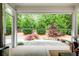 Cozy back porch offering privacy and a beautiful view of the meticulously landscaped backyard at 164 Inwood Walk, Woodstock, GA 30188