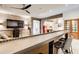 Finished basement with a custom-built bar area, brick walls, and a flat-screen television at 164 Inwood Walk, Woodstock, GA 30188