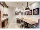 Finished basement features a dining area with an industrial-style sink, table and benches at 164 Inwood Walk, Woodstock, GA 30188