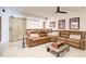 Finished basement with a comfortable leather sectional, decor, and ceiling fan at 164 Inwood Walk, Woodstock, GA 30188