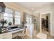 Bathroom features a vanity area, large glass shower, and a walk-in closet for storage at 164 Inwood Walk, Woodstock, GA 30188